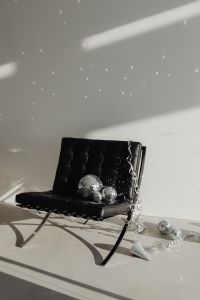 Kaboompics - Moody Disco Ball Still Life on Black Lounge Chair with Metallic Confetti