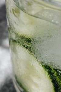 Kaboompics - Extreme Close-Up of Condensation on Cucumber-Infused Water, Abstract Green Detox Drink Texture