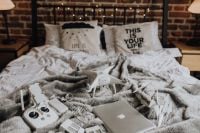 Kaboompics - Drone, laptop and accessories lie on the bed ready for travel