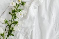 Kaboompics - White Blossoms Along the Left Edge of a Soft Linen Mockup Background