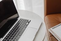 Kaboompics - Close-Up Laptop Keyboard and Weekly Planner on White Table, Remote Work Productivity Content