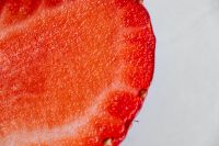 Kaboompics - Cut Strawberry Cross-Section Against White, Bright Red Fruit Background for Recipe Graphics