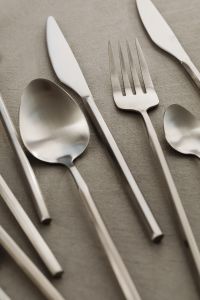 Kaboompics - Close-Up Stainless Steel Fork, Spoon and Knife Arrangement on Gray Surface