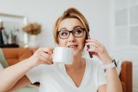 Kaboompics - Woman Talking on the Phone While Enjoying Coffee During Remote Work
