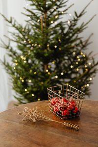 Kaboompics - Red Christmas Ornaments in a Wire Basket by the Tree