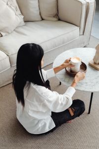 Kaboompics - Woman Lighting a Candle on a Marble Table