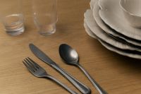 Kaboompics - Silver Cutlery Beside Stacked White Ceramic Plates and Ribbed Glasses on Wood
