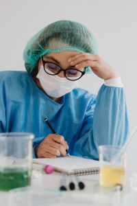 Kaboompics - Tired Female Scientist in Protective Laboratory Gear