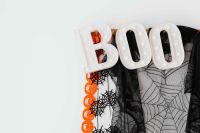 Kaboompics - Halloween BOO Sign with Spiderweb Cloth and Pumpkin Garland