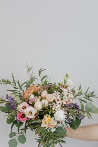 Kaboompics - Centered Mixed Flower Bouquet on a Gray Wall with Generous Negative Space