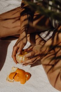 Kaboompics - Sunbathing Woman with Peeled Orange and Striped Swimsuit