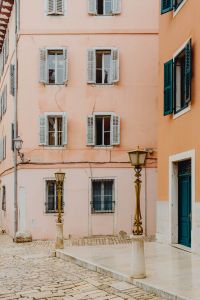 Kaboompics - Tall Pastel Pink Rovinj Facade with Green Doors, Turquoise Shutters and Lamps