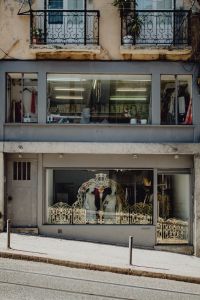 Kaboompics - Bridal Boutique Windows beneath Ornate Lisbon Balconies