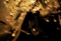 Kaboompics - Golden Motion Blur and Light Streaks around Black Center, Abstract Background Texture