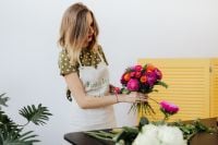 Kaboompics - Florist Displaying a Colorful Bouquet with Both Hands