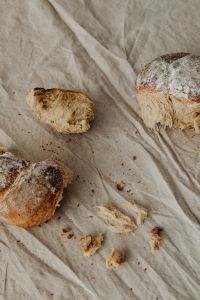 Kaboompics - Bread Crumbs and Torn Loaves on Linen