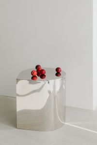Kaboompics - Minimal Chrome Table with Red Plums