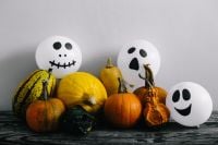 Kaboompics - Halloween Decorations with Skeleton Figures, Ghost Balloons and Pumpkins