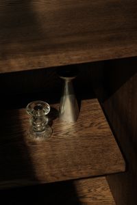 Kaboompics - Glass Candle Holder and Silver Metal Vase in Warm Sunlight