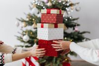 Kaboompics - Stack of Christmas Presents Held by Multiple Hands