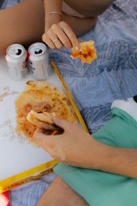 Kaboompics - Overhead Beach Picnic with Pizza and Two Canned Drinks