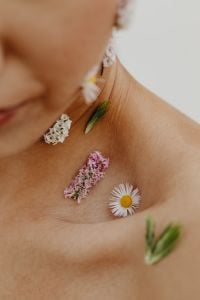Kaboompics - Macro of Tiny White and Pink Flowers on Bare Neck and Shoulder