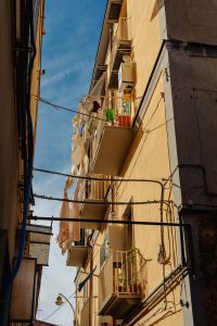 Kaboompics - Narrow Naples Alley With Projecting Balconies and Utility Wires