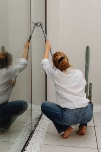 Kaboompics - Close-Up of Woman Using a Squeegee on Glass