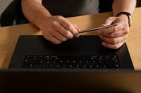 Kaboompics - Man Holding a Stylus Over a Laptop
