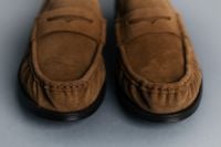 Kaboompics - Pair of Brown Suede Loafers on Cool Blue Background