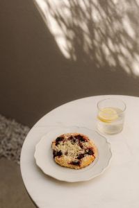Kaboompics - Cherry Pastry and Lemon Water on a White Round Table