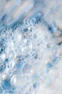 Kaboompics - Blue-White Skincare Foam Macro with Dense Soap Bubbles and Sweeping Cream Streaks