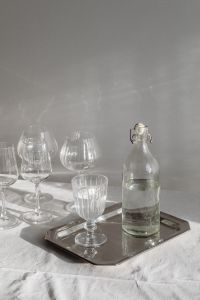 Kaboompics - Glassware and Bottle on Silver Tray over White Tablecloth