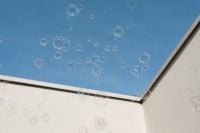 Kaboompics - Soap Bubbles against Blue Sky Framed by White Building Walls