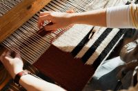 Kaboompics - Woman Working on a Geometric Woven Textile