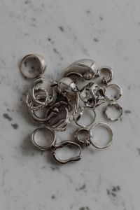 Kaboompics - Silver Jewelry on Speckled Gray Stone Surface