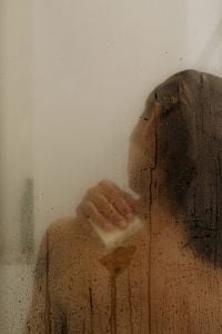 Kaboompics - Woman Showering Behind Steamy Glass