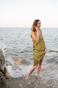 Kaboompics - Side View of a Woman Calling by the Water, Green Dress and Calm Seaside Lifestyle