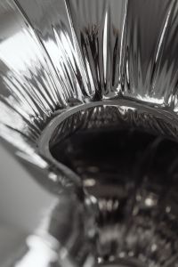 Kaboompics - Extreme Close-Up Inside a Ribbed Chrome Vessel, Abstract Reflective Silver Texture