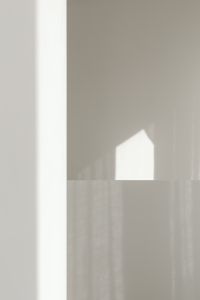 Kaboompics - Geometric Sunlight and Shadows on a Textured Wall