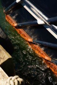 Kaboompics - Fishing Boat Hull Reflection on Harbor Water
