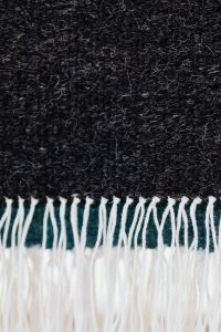 Kaboompics - Black Woven Fabric with Long White Fringe