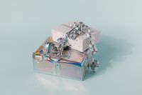 Kaboompics - Stacked Holographic and White Gift Boxes on Blue