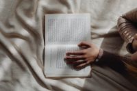 Kaboompics - Person Reading an Open Book on a Beige Blanket