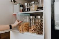 Kaboompics - Containers of cereals in kitchen cupboard
