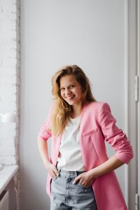 Kaboompics - Confident Blonde Fashion Portrait in a Pink Blazer with Minimal White Background