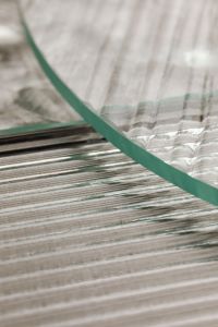 Kaboompics - Portrait Close-Up of a Curved Glass Rim over Linear Texture
