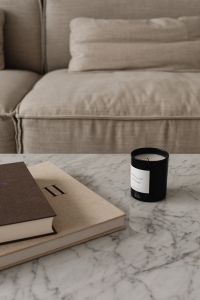 Kaboompics - Neutral Living Room Sofa with Coffee Table Books and Candle