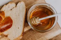 Kaboompics - Honey Jar With Challah Slices on Wooden Board