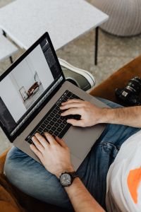 Kaboompics - Photographer Editing Photos on Laptop with Camera Nearby